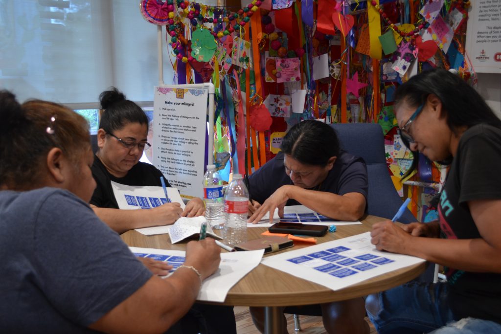 Community members actively participating in a workshop for the Alazan Courts Master Plan, demonstrating Able City's commitment to inclusive community engagement.